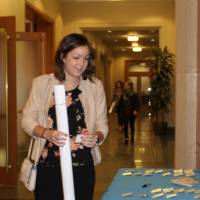 People gathered around the welcome table, looking at nametags